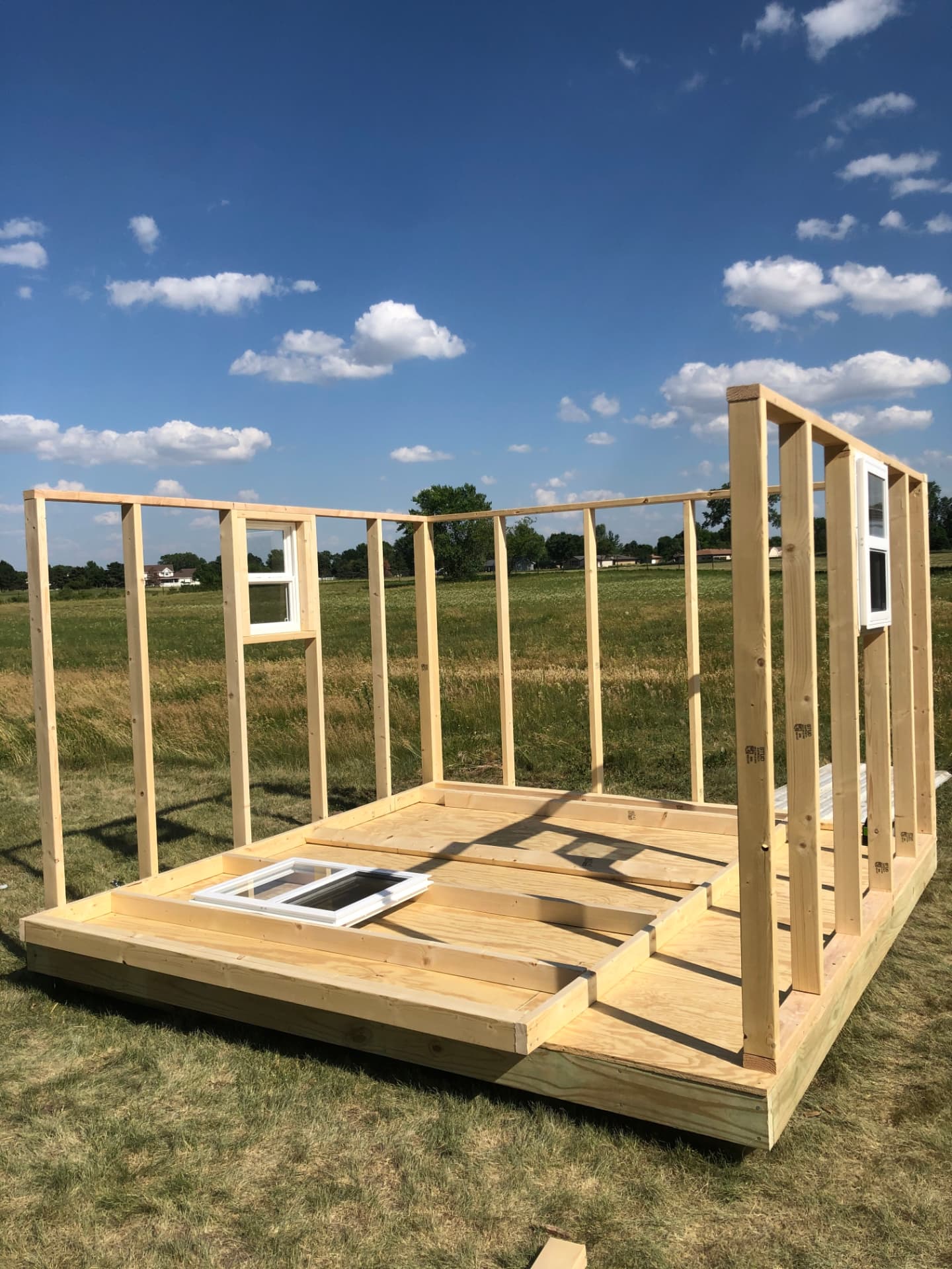 The framed walls of the God cave shed standing in a field