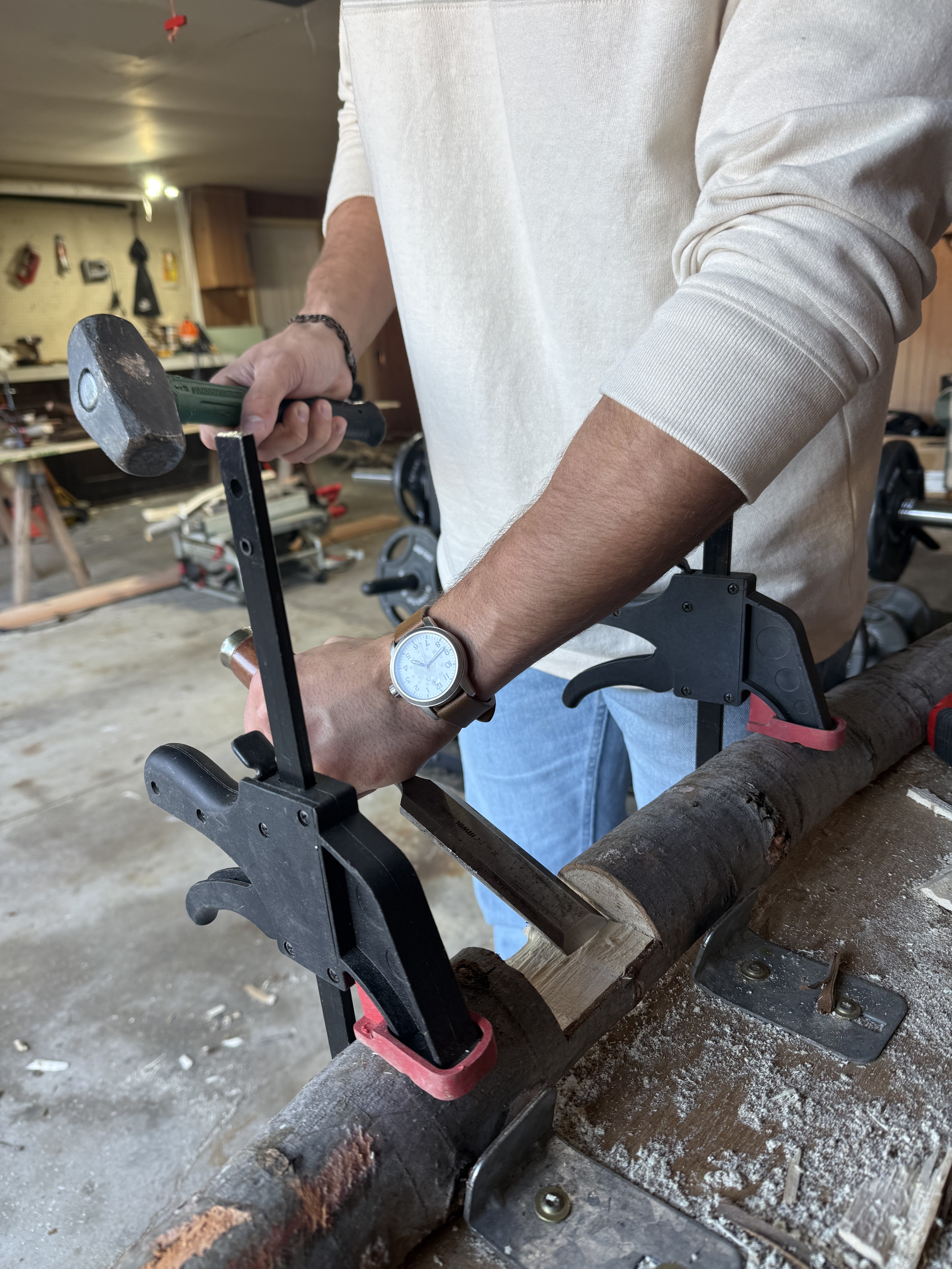Danny Fisher shaping a branch with a chisel and mallet